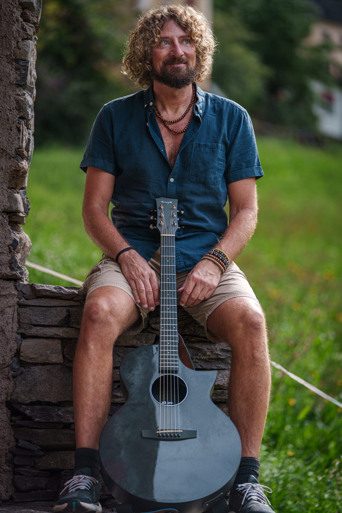 Pat playing acoustic guitar