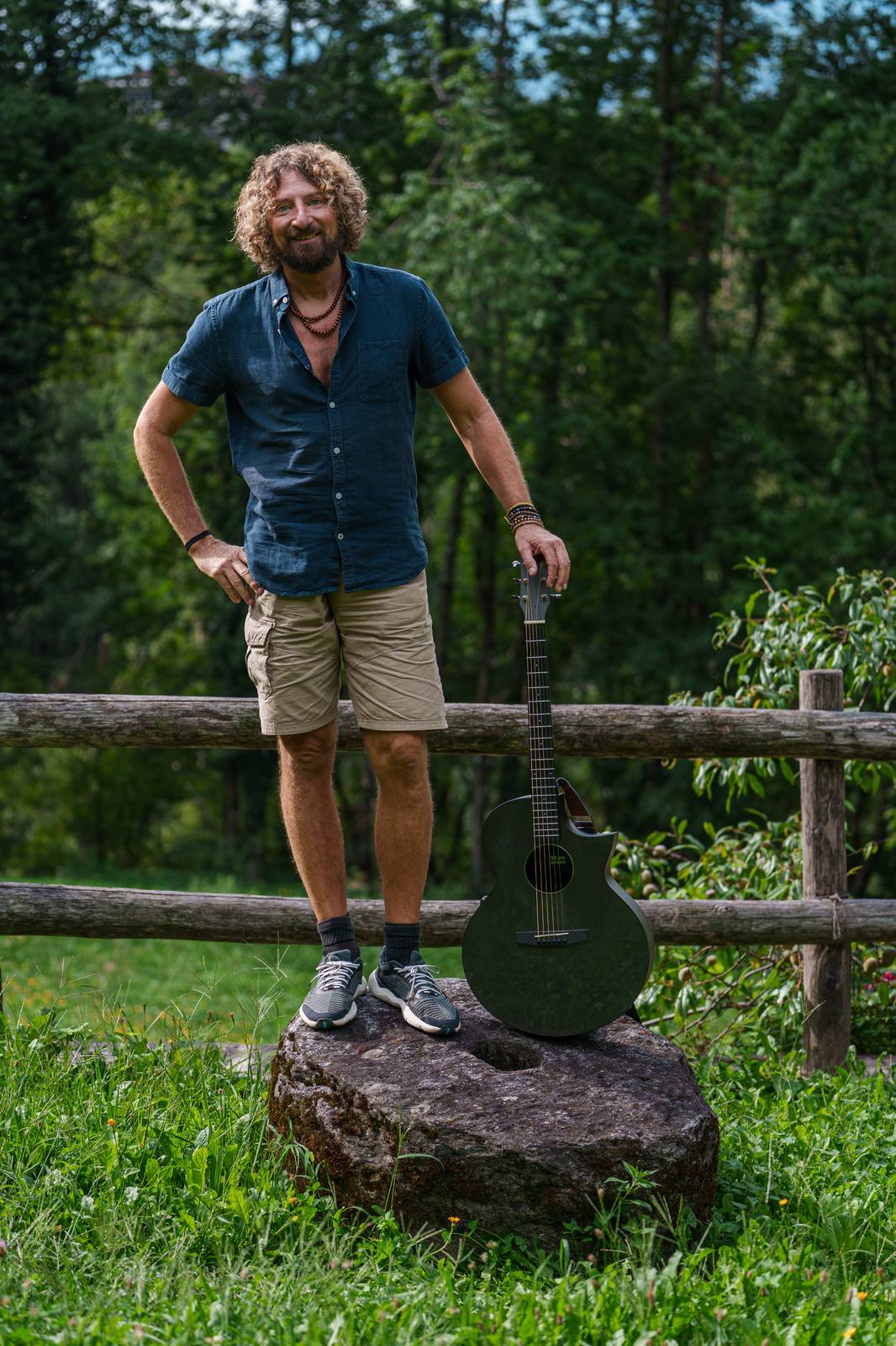 Pat standing on a stone, full body, smiling