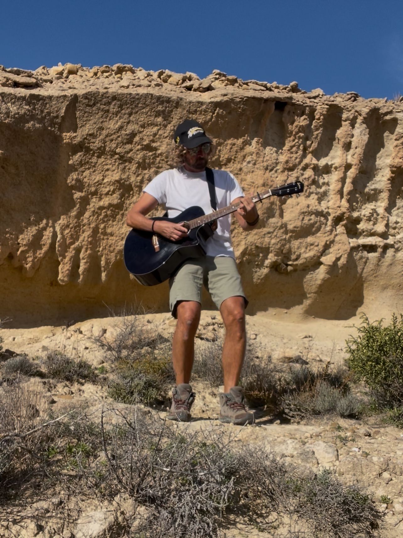 Pat performing outdoors with guitar